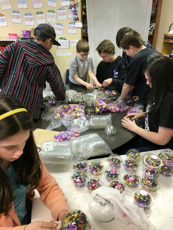 kids assembling gift cups to sell for entrepreneur class