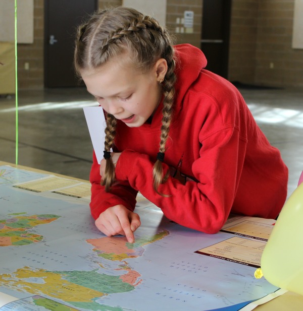 girl finding a location on a map