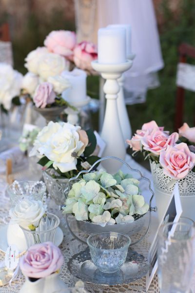 beautiful bowls filled with tasty food and vases filled with flowers for a tea party